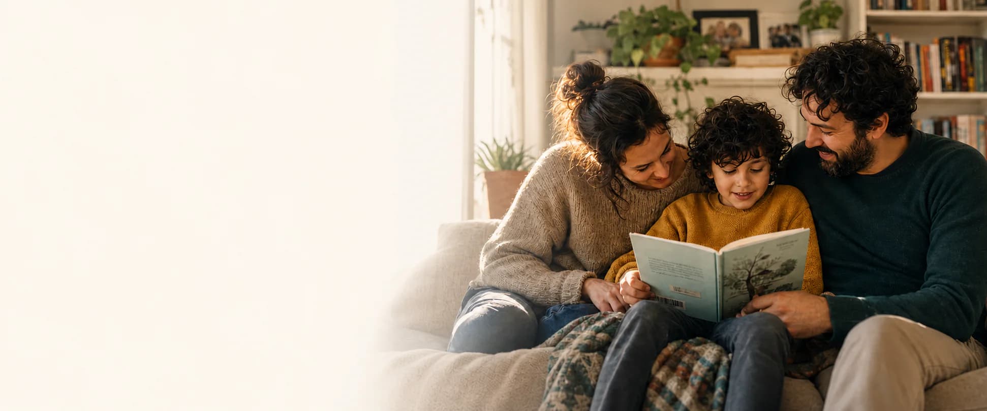 A family reading together on a sofa